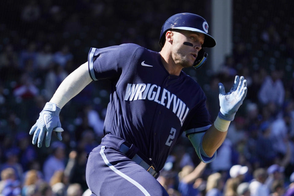 Chicago Cubs' Nico Hoerner runs after hitting a two-run double during the second inning of a baseball game against the Cincinnati Reds in Chicago, Friday, Sept. 30, 2022. (AP Photo/Nam Y. Huh)