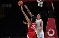 Japan's Tenketsu Harimoto (88) and Argentina's Luis Scola (4) reach for a rebound during men's basketball preliminary round game at the 2020 Summer Olympics, Sunday, Aug. 1, 2021, in Saitama, Japan. (AP Photo/Eric Gay)