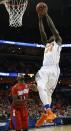 Florida forward Casey Prather (24) shoots against Dayton guard Scoochie Smith (11) during the first half in a regional final game at the NCAA college basketball tournament, Saturday, March 29, 2014, in Memphis, Tenn. (AP Photo/Mark Humphrey)