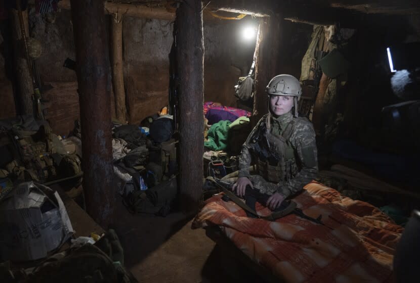 Ukrainian platoon commander Mariia rests in a trench in a position in the Donetsk region, Ukraine, Saturday, July 2, 2022. Ukrainian soldiers returning from the frontlines in eastern Ukraine's Donbas region describe life during what has turned into a grueling war of attrition as apocalyptic. Mariia, 41, said that front-line conditions may vary depending on where a unit is positioned and how well supplied they are. (AP Photo/Efrem Lukatsky)