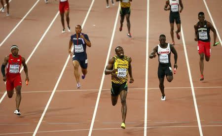 Usain Bolt of Jamaica (C) competes in the men's 4 x 100 metres relay finalduring the 15th IAAF World Championships at the National Stadium in Beijing, China August 29, 2015. REUTERS/David Gray