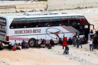 People, who were evacuated from the two rebel-besieged Shi'ite villages of al-Foua and Kefraya, wait near buses at insurgent-held al-Rashideen, to travel to government-controlled Aleppo, Syria April 19, 2017. REUTERS/Ammar Abdullah