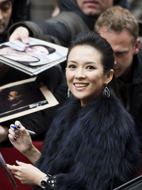 Chinese actress Zhang Ziyi gives autographs to her fans as she arrives for a photocall and a press conference for the film Yi dai zong shi (The Grandmaster) in Berlin, February 7, 2013. The 63rd Berlin film festival opens with a gala screening of Chinese director Wong Kar Wai's martial arts epic about the mentor of kung fu superstar Bruce Lee