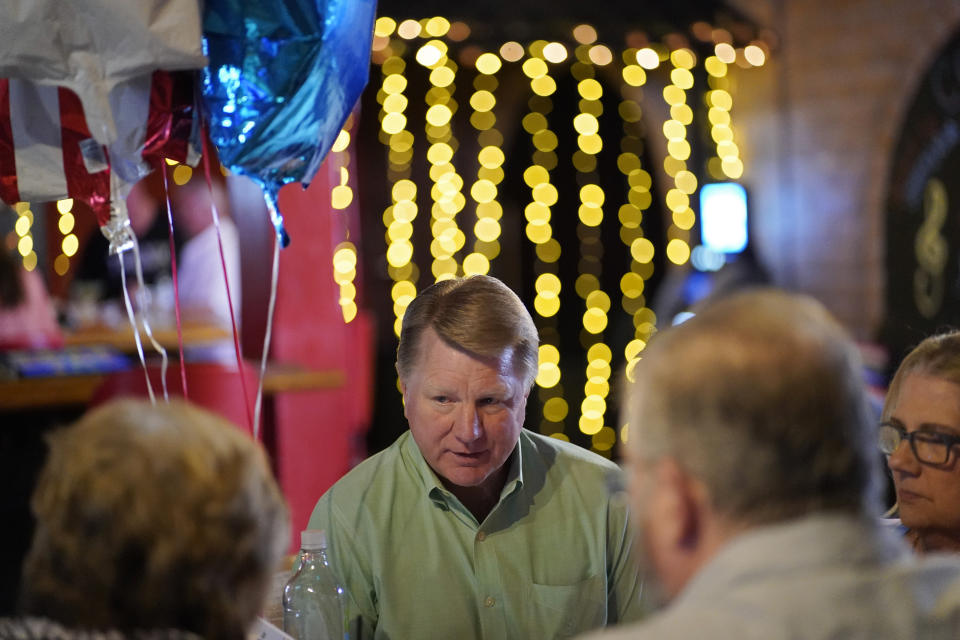 Jim Marchant, center, the GOP nominee for secretary of state in Nevada, speaks with people at a political event July 16, 2022, in Pahrump, Nev. (AP Photo/John Locher)