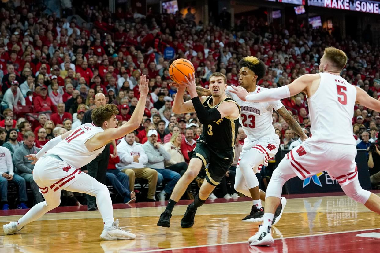 Purdue's Braden Smith (3) drives against Wisconsin's Max Klesmit (11), Chucky Hepburn (23) and Tyler Wahl, right, during the first half of an NCAA college basketball game Sunday, Feb. 4, 2024, in Madison, Wis. (AP Photo/Andy Manis)