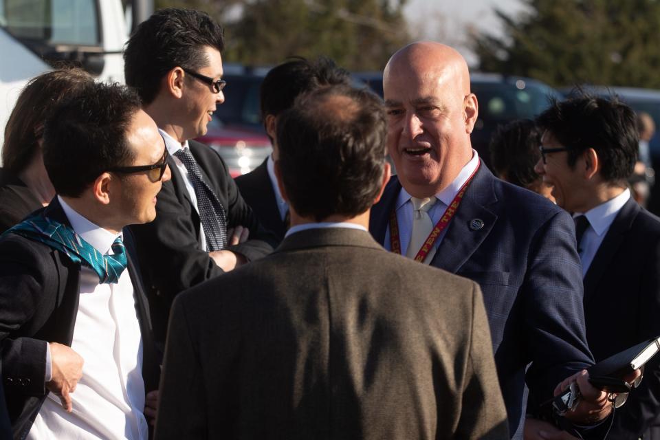 Paul Hughes, right, former deputy secretary of the Kansas commerce department, spoke to colleagues before the groundbreaking ceremony for the new Panasonic plant in DeSoto on Nov. 2.