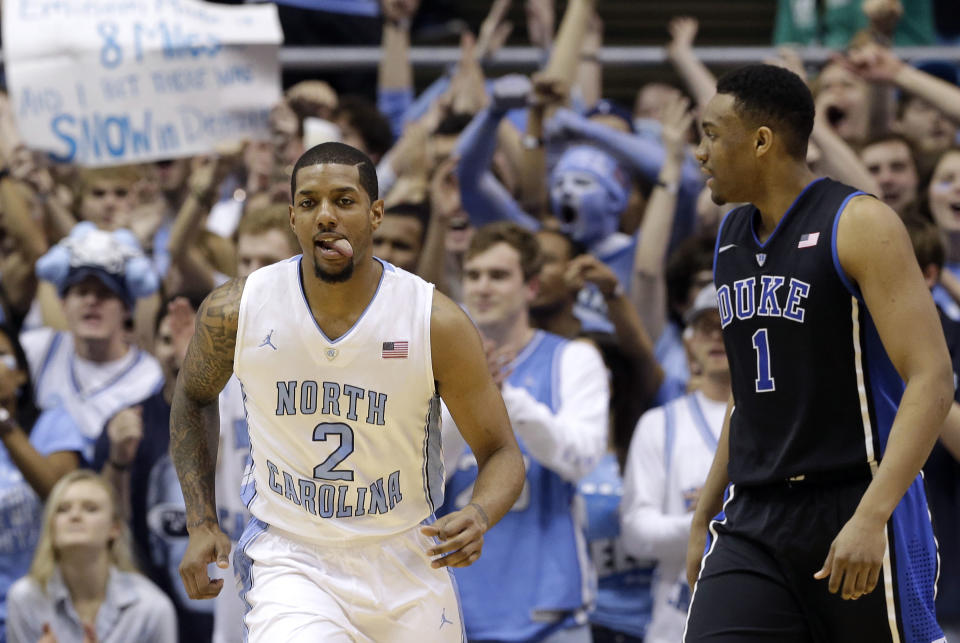 North Carolina's Leslie McDonald (2) reacts following a basket, next to Duke's Jabari Parker (1) during the first half of an NCAA college basketball game in Chapel Hill, N.C., Thursday, Feb. 20, 2014. North Carolina won 74-66. (AP Photo/Gerry Broome)