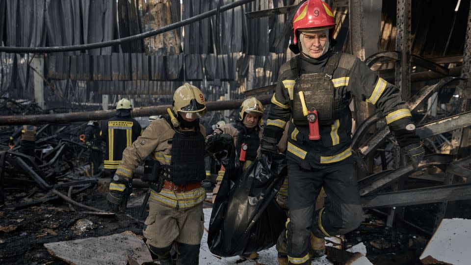 Emergency workers carry out the body of a victim of a Russian strike that hit a large store in Kharkiv. - Kostiantyn Liberov/Libkos/Getty Images