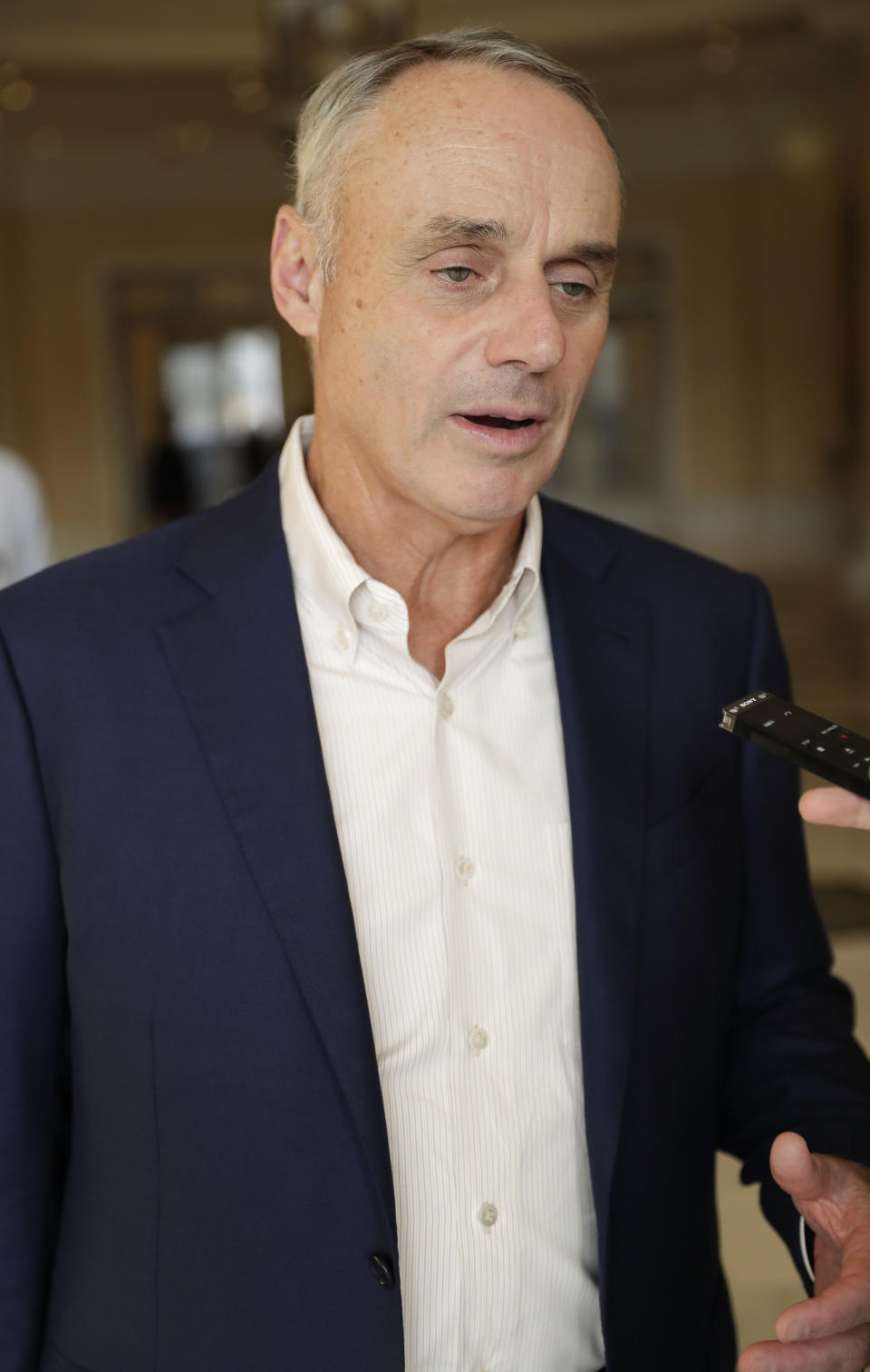 Rob Manfred, commissioner of Major League Baseball, talks to reporters at the end of the day's conferences at MLB baseball owners meetings Thursday, Feb. 7, 2019, in Orlando, Fla. (AP Photo/John Raoux)