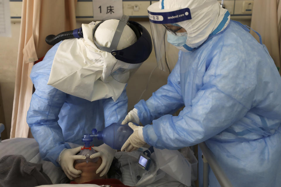 In this Sunday, Feb. 16, 2020, photo, medical workers pump oxygen for a new coronavirus patient at a hospital in Wuhan in central China's Hubei province. Chinese authorities on Monday reported a slight upturn in new virus cases and hundred more deaths for a total of thousands since the outbreak began two months ago. (Chinatopix via AP)