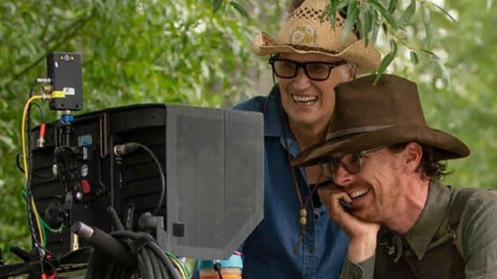 Jane Campion standing beside Benedict Cumberbatch, both looking into a camera in a behind-the-scenes from Power of the Dog.