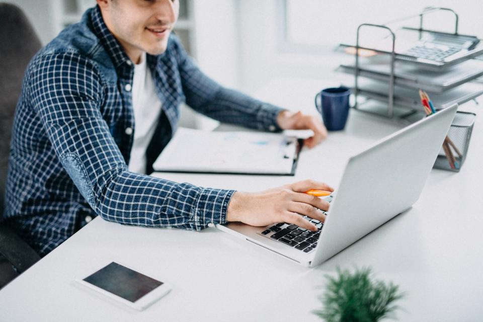 An investor works at a laptop in an office.