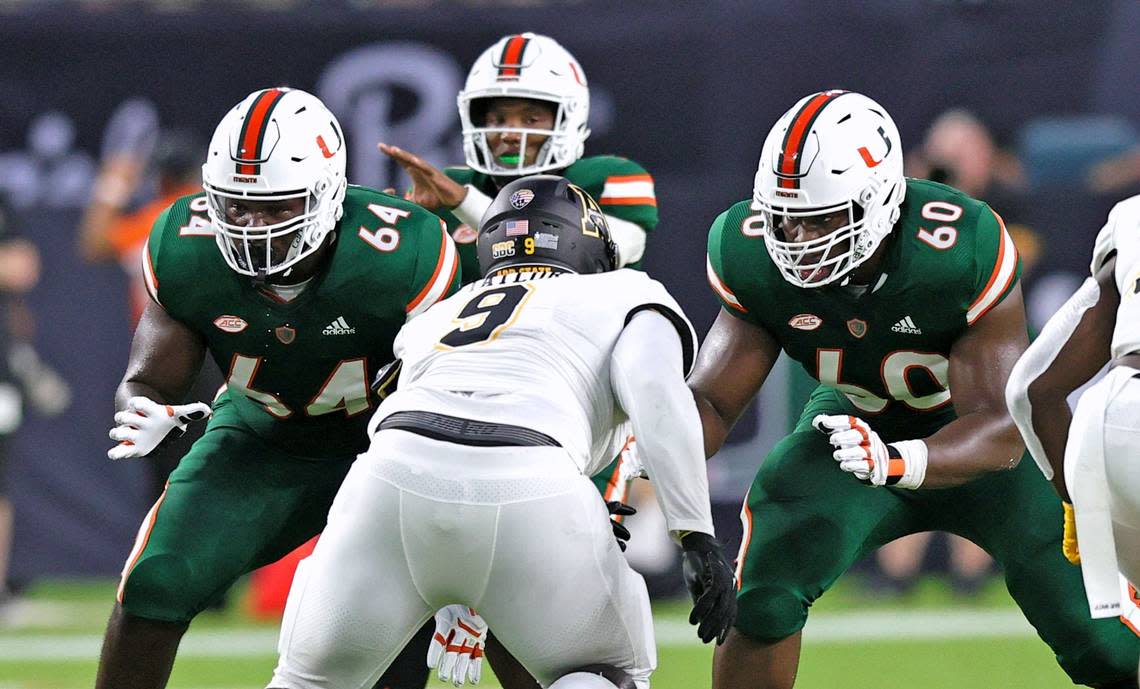 Miami Hurricanes offensive lineman Jalen Rivers (64) and Zion Nelson (60) protecting quarterback D’Eriq King (1) from Appalachian State Mountaineers defensive lineman Demetrius Taylor (9) during the first quarter of their ACC football game at Hard Rock Stadium on Saturday, September 11, 2021 in Miami Gardens, Florida. David Santiago/dsantiago@miamiherald.com