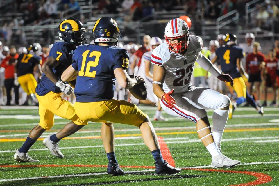 Arrowhead defensive lineman Jace Gilbert (23) pressures Marquette quarterback Peter McDevitt (12) in an Aug. 18 game in Wauwatosa, Wis.