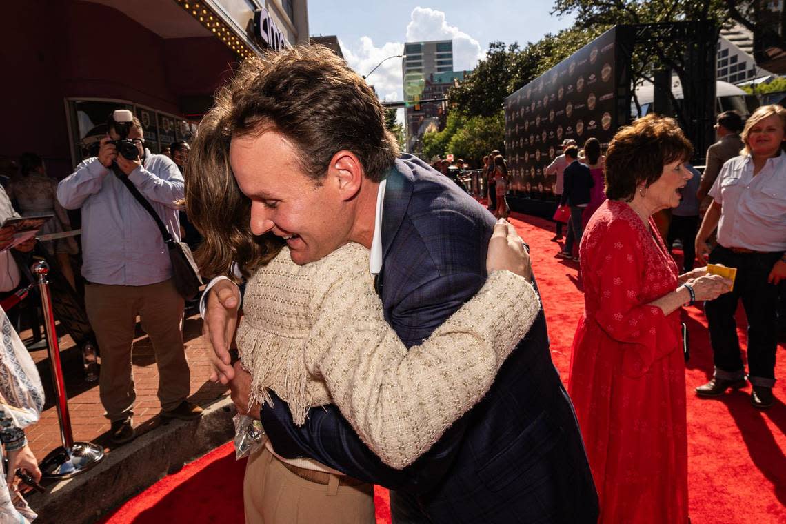 Actor Michael Cash, who plays Young Robert Ratliff, embraces the real Robert Ratliff on the red carpet for the world premiere of the movie “You Gotta Believe” outside of the AMC Palace 9 Theatre in downtown Fort Worth on Thursday, Aug. 29, 2024. The film is based on the 2002 Westside Little League baseball team’s run to the World Series, after the team was inspired by a teammate’s father’s cancer diagnosis.