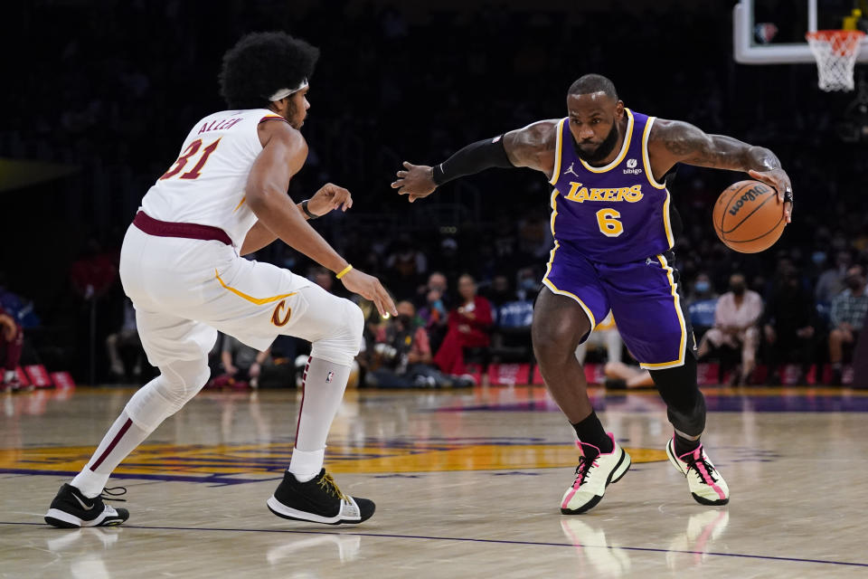 Los Angeles Lakers' LeBron James, right, drives around Cleveland Cavaliers' Jarrett Allen during the first half of an NBA basketball game Friday, Oct. 29, 2021, in Los Angeles. (AP Photo/Jae C. Hong)