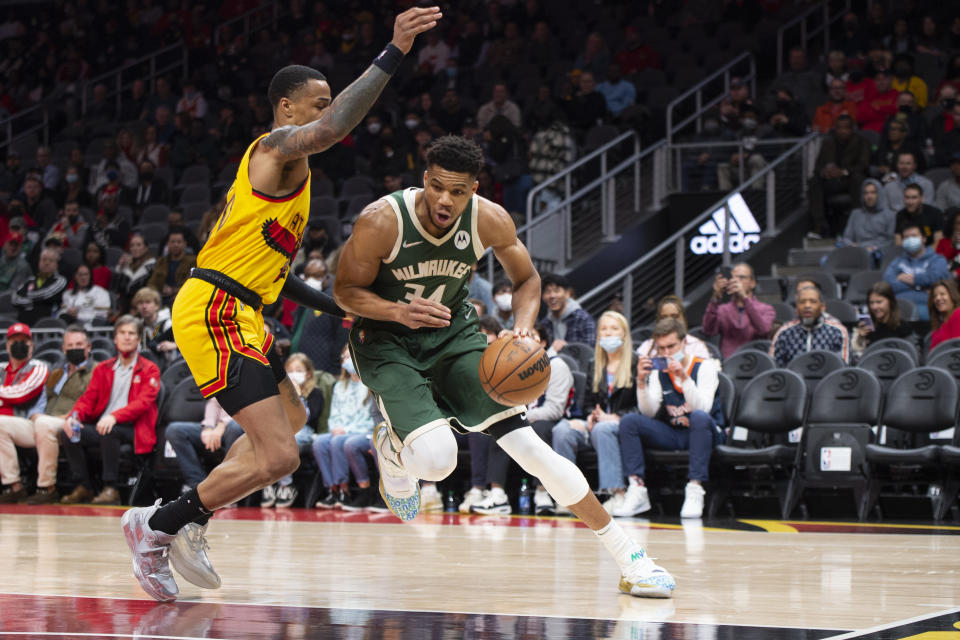 Milwaukee Bucks forward Giannis Antetokounmpo (34) drives past Atlanta Hawks forward John Collins (20) during the first half of an NBA basketball game Monday, Jan. 17, 2022, in Atlanta. (AP Photo/Hakim Wright Sr.)