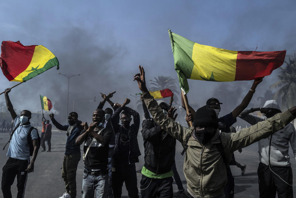 Demonstrators protest against the arrest of opposition leader and former presidential candidate Ousmane Sonko in Dakar, Senegal, Friday, March 5, 2021. Days of violent protests in Senegal have killed at least one person, local reports say, as young people take to the streets nationwide in support of the main opposition leader who was detained Wednesday. (AP Photo/Sylvain Cherkaoui)