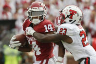 Texas Tech defensive back Damarcus Fields (23) reaches in to tackle Oklahoma wide receiver Charleston Rambo (14) in the first quarter of an NCAA college football game in Norman, Okla., Saturday, Sept. 28, 2019. (AP Photo/Sue Ogrocki)