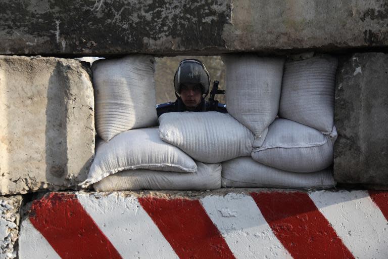 A Ukrainian policeman guards a check-point at the entrance of the southeastern Ukrainian city of Berdyansk on April 19, 2014