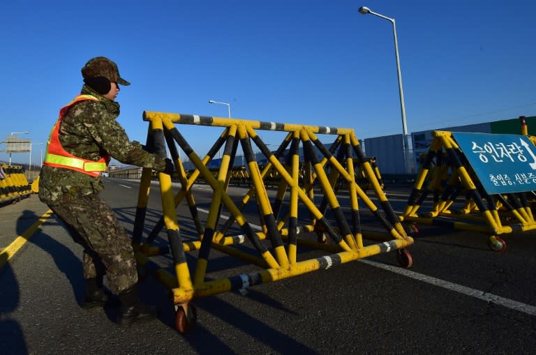 A South Korean soldier sets a barricade on the road leading to North Korea's Kaesong joint industrial complex at a military checkpoint in the border city of Paju near the Demilitarized zone dividing the two Koreas on January 8, 2016