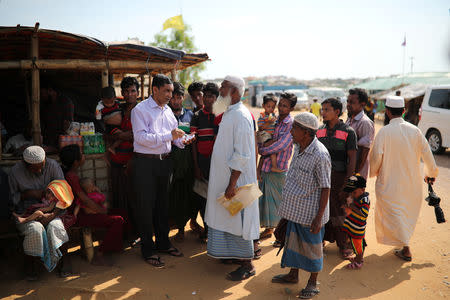 Mohib Ullah, a leader of Arakan Rohingya Society for Peace and Human Rights, speaks to other Rohingya people who face problem to collect relief supplies in Kutupalong camp in Cox's Bazar, Bangladesh April 7, 2019. REUTERS/Mohammad Ponir Hossain