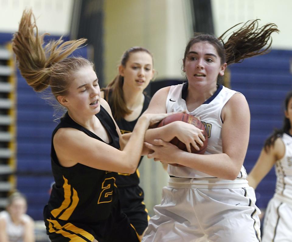 HF-L's Teagan Kamm, left, ties the ball up with Pittsford Sutherland's Libby Kenneally during a regular season game played at Pittsford Sutherland High School on Thursday, Nov. 29, 2018. Pittsford Sutherland beat Honeoye Falls-Lima in overtime 53-47.