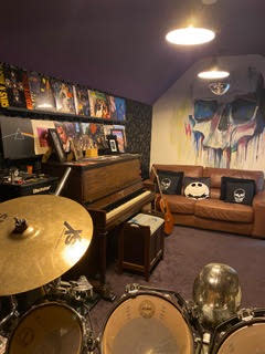 Inside the garage-turned-band room with its hand-painted mural. (Image: Katy Raywood) 