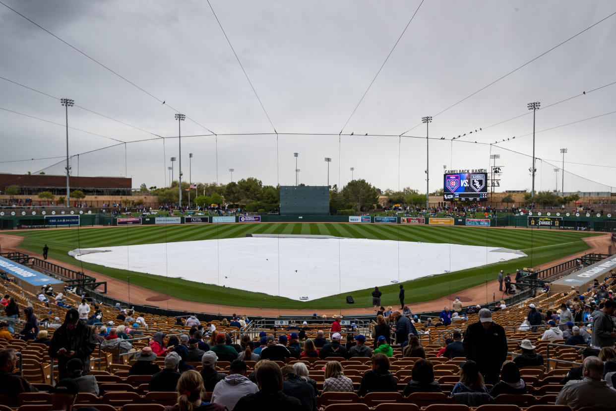 SURPRISE, ARIZONA - MARCH 15: A tarp covers the infield during a rain delay before the Spring Training game between the Chicago Cubs and the Chicago White Sox at Surprise Stadium on March 15, 2024 in Surprise, Arizona. (Photo by John E. Moore III/Getty Images)