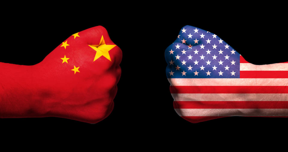 Two fists emblazoned with U.S. and Chinese flags meet.