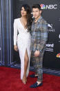 Priyanka Chopra and Nick Jonas of Jonas Brothers posed together on the red carpet at the 2019 Billboard Music Awards at MGM Grand Garden Arena on May 01, 2019 in Las Vegas, Nevada. Chopra wore a plunging white gown by Zuhair Murad paired with Tiffany & Co. jewellery, while Nick wore a checked suit. <em>[Photo by Frazer Harrison/Getty Images]</em>