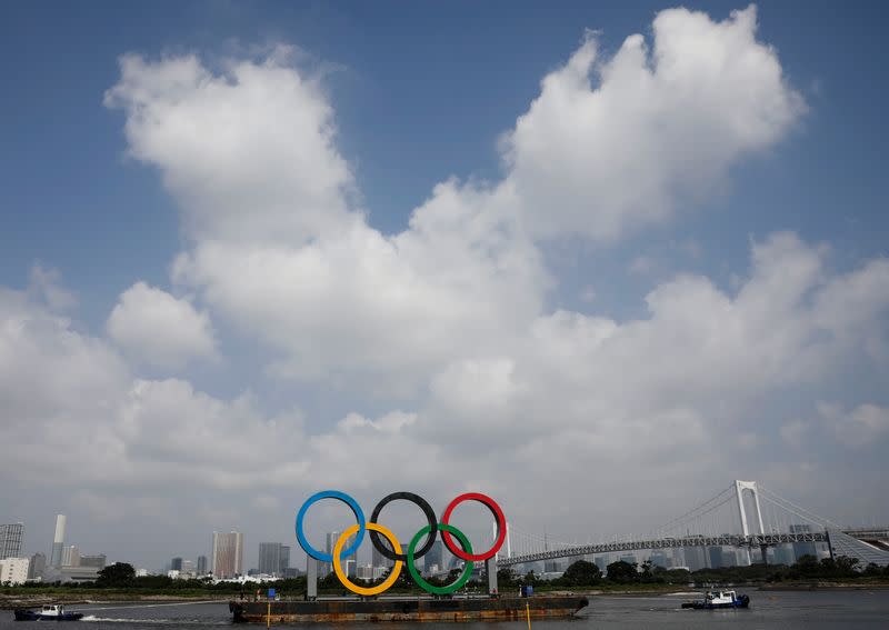 The giant Olympic rings are being temporarily removed for maintenance, amid the coronavirus disease (COVID-19) outbreak, at the waterfront area at Odaiba Marine Park in Tokyo