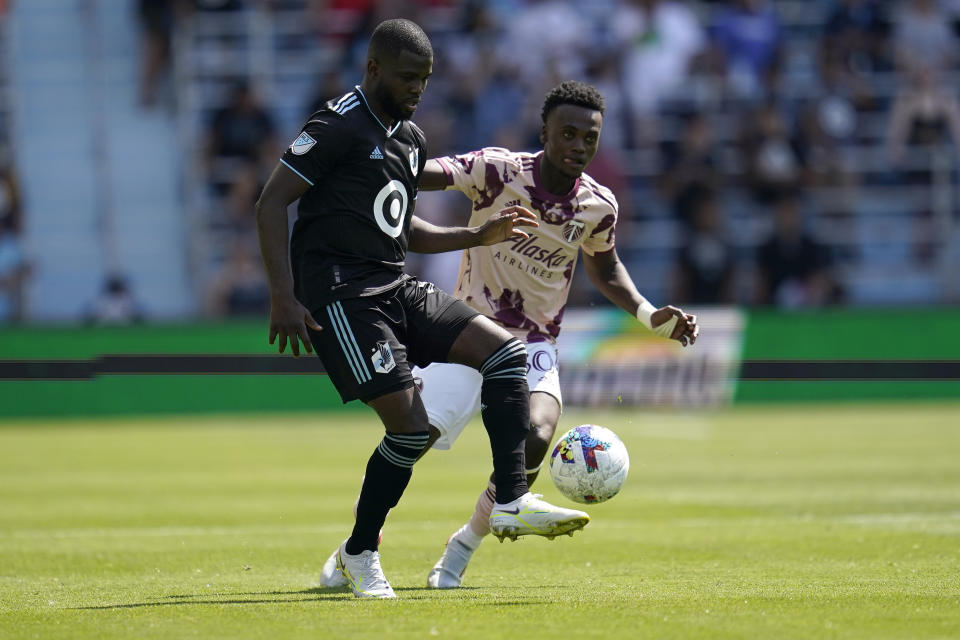 Minnesota United defender Kemar Lawrence (92) controls the ball against Portland Timbers midfielder Santiago Moreno (30) during the second half of an MLS soccer match at Allianz Field in Saint Paul, Minn., Saturday, July 30, 2022. (AP Photo/Abbie Parr)