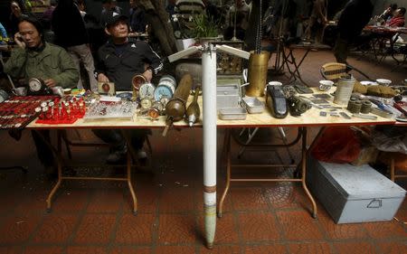 A missile from a U.S. military helicopter which was used during the Vietnam War is seen displayed for sale with other items at an old items market in Hanoi March 14, 2015. REUTERS/Kham