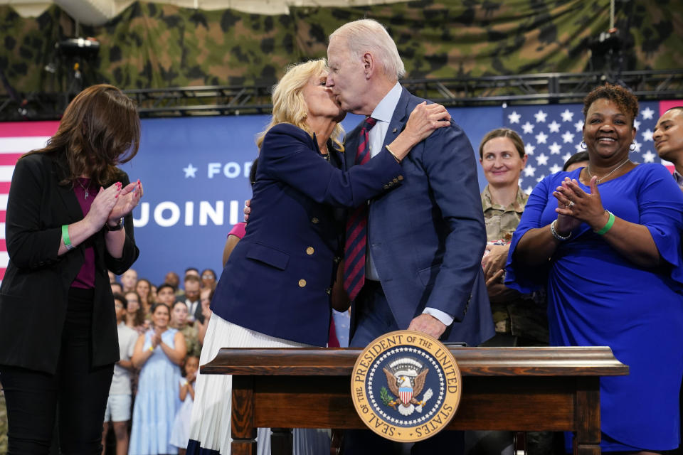 President Joe Biden kisses first lady Jill Biden after he signed an executive order during a visit to Fort Liberty, N.C., Friday, June 9, 2023. Biden signed an executive order on Friday that aims to bolster job opportunities for military and veteran spouses whose careers are often disrupted by their loved ones' deployments, telling them "we never forget that you've also answered the nation's call." (AP Photo/Susan Walsh)