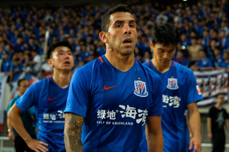 Carlos Tevez leaves the pitch after his Shenhua side lost 6-1 in the Shanghai derby to SIPG at the weekend