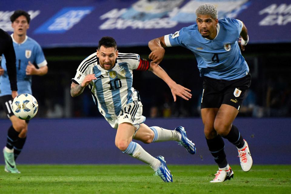 Uruguay's defender Ronald Araujo fouls Argentina's forward Lionel Messi during a 2026 FIFA World Cup qualifier.