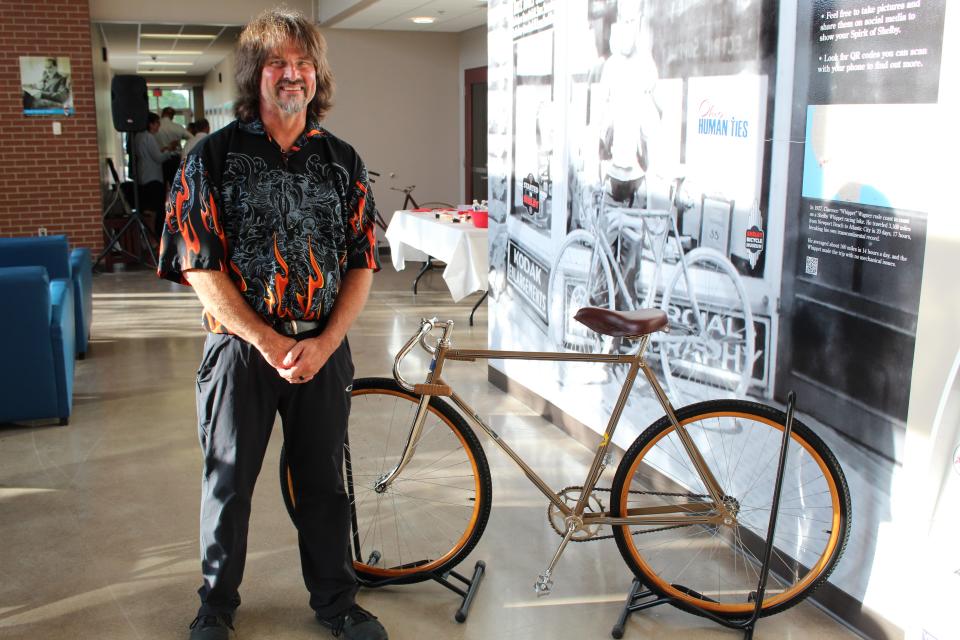 Tim Newmeyer stands next to the historic bike on which Clarence "Whippet" Wagner set a transcontinental record in 1927. Newmeyer found the bicycle in the Dallas, Texas, area and fixed it up for display in the new Shelby Bicycle Museum.