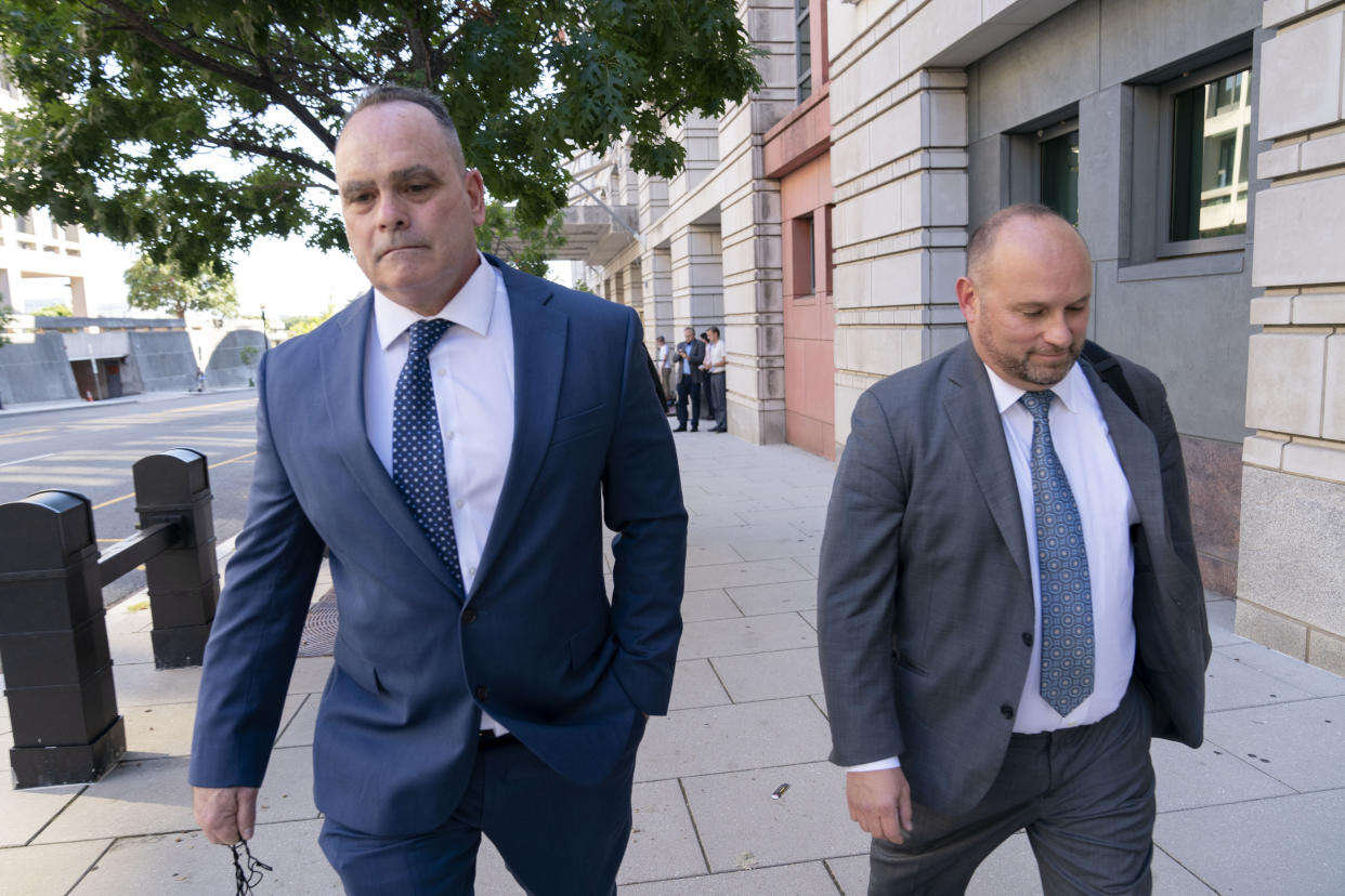 Retired New York Police Department officer Thomas Webster accompanied by his attorney James Monroe leaves the federal courthouse in Washington, Thursday, Sept. 1, 2022. Webster was sentenced on Thursday to 10 years in prison for attacking the U.S. Capitol and using a metal flagpole to assault one of the police officers trying to hold off a mob of Donald Trump supporters. (AP Photo/Jose Luis Magana)