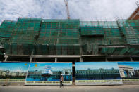 A construction work walks at the construction side in Diamond Island also known as 'Koh Pich' in Phnom Penh, Cambodia, May 23, 2018. Picture taken May 23, 2018. REUTERS/Samrang Pring