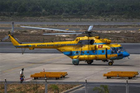 A Vietnamese helicopter taxies at Phu Quoc Airport before being utilised in the mission to find the Malaysia Airlines flight MH370 in Phu Quoc Island, March 11, 2014. REUTERS/Athit Perawongmetha