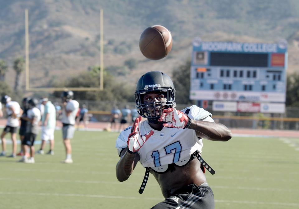 Running back Jyden King keeps his eyes on the ball while making a reception during a Moorpark College football team practice on Wednesday. The Raiders open their season at Ventura College on Saturday night.