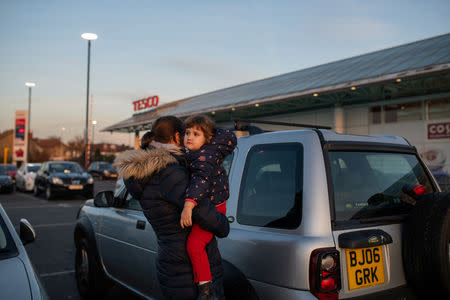 Maria, 31, carries her daughter Elena, who is two years and seven-months old, during a shopping trip in London, Britain, February 22, 2019. REUTERS/Alecsandra Dragoi