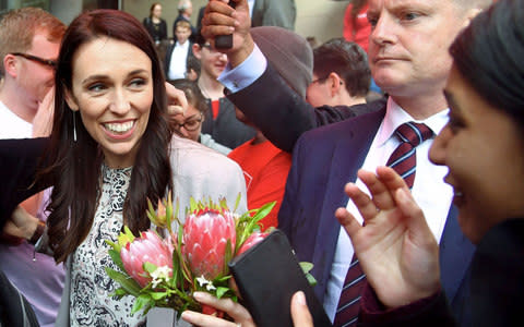 Leader of the Labour Party Jacinda Ardern is mobbed by university students during a visit to Victoria University in Wellington on September 19, 2017 - Credit:  AFP/ MARTY MELVILLE