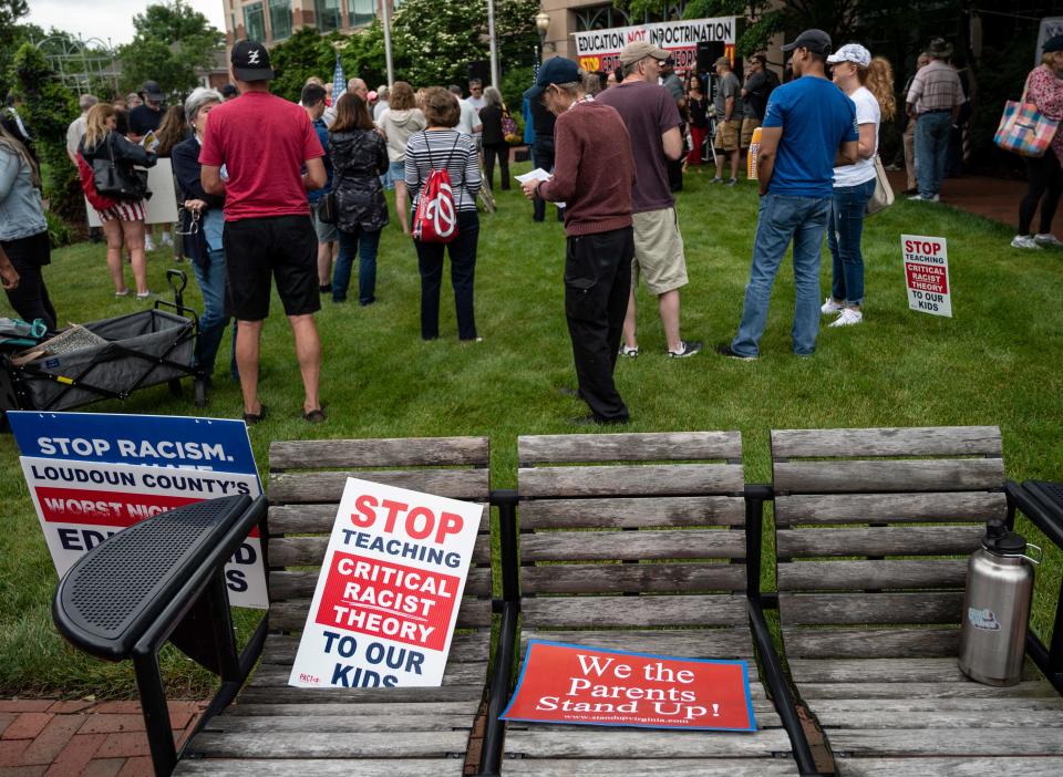 Signs on a bench during a rally against critical race theory being taught in schools at the Loudoun County Government Center in Leesburg, Virginia, on June 12, 2021.