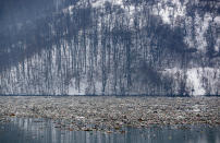 Plastic bottles and waste float at the Potpecko accumulation lake near Priboj, in southwest Serbia, Friday, Jan. 22, 2021. Serbia and other Balkan nations are virtually drowning in communal waste after decades of neglect and lack of efficient waste-management policies in the countries aspiring to join the European Union. (AP Photo/Darko Vojinovic)