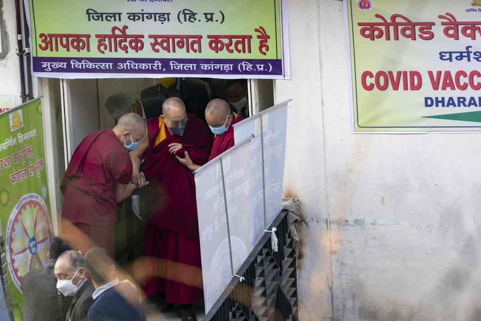 Tibetan spiritual leader the Dalai Lama is helped by two monks as he leaves the Zonal Hospital after receiving a shot of the COVID-19 vaccine in Dharmsala, India, Saturday, March 6, 2021. Medical officers confirmed that the Tibetan leader got the Covishield vaccine and is not showing any adverse reaction to the vaccine. (AP Photo/Ashwini Bhatia)