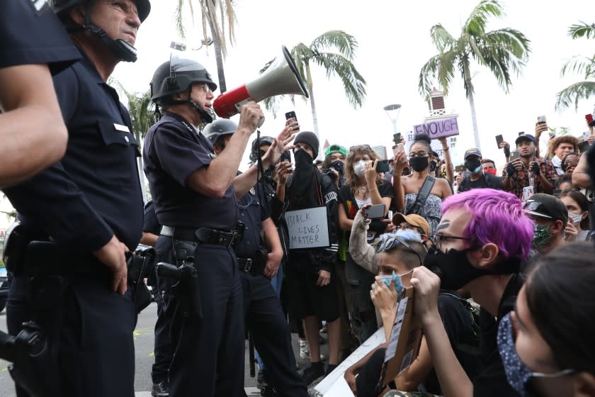 Chief of Police of Los Los Angeles, Michel Moore, address protesters at 3rd and Fairfax, in front of the Farmers Market on Saturday, May 30, 2020.