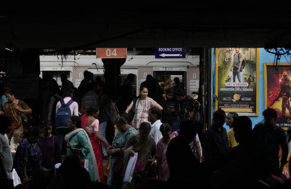 Women walk at a local train station at Dadar, in Mumbai, India, Monday, March 20, 2023. The Center for Monitoring the Indian Economy (CMIE), which uses a more restrictive definition of employment, found that only 10% of working age Indian women in 2022 were either employed or looking for jobs. This means there are only 39 million women employed in the workforce compared to 361 million men. (AP Photo/Rajanish Kakade)