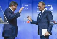 Turkish Prime Minister Ahmet Davutoglu (L) and European Council President Donald Tusk greet each other after a news conference following a EU-Turkey summit in Brussels, Belgium November 29, 2015. REUTERS/Yves Herman